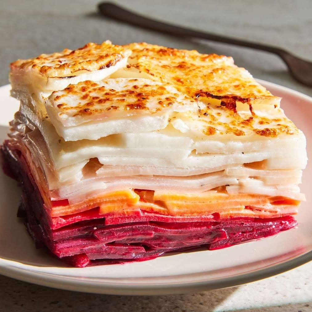 Layered root vegetable gratin with beets, sweet potato, and turnip