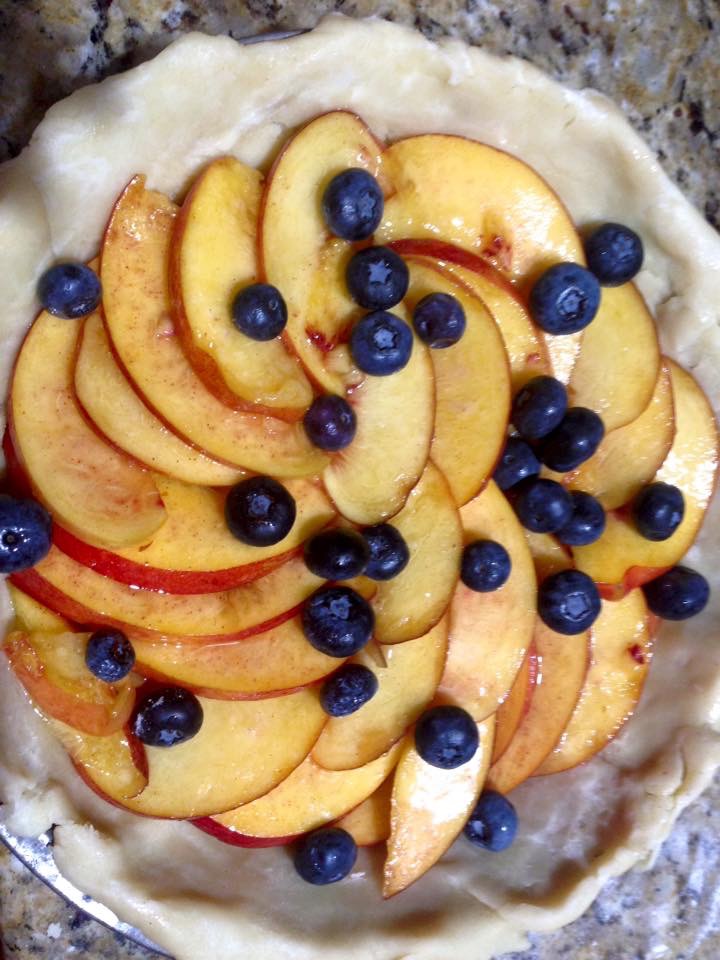 Peach and blueberry galette on rustic crust
