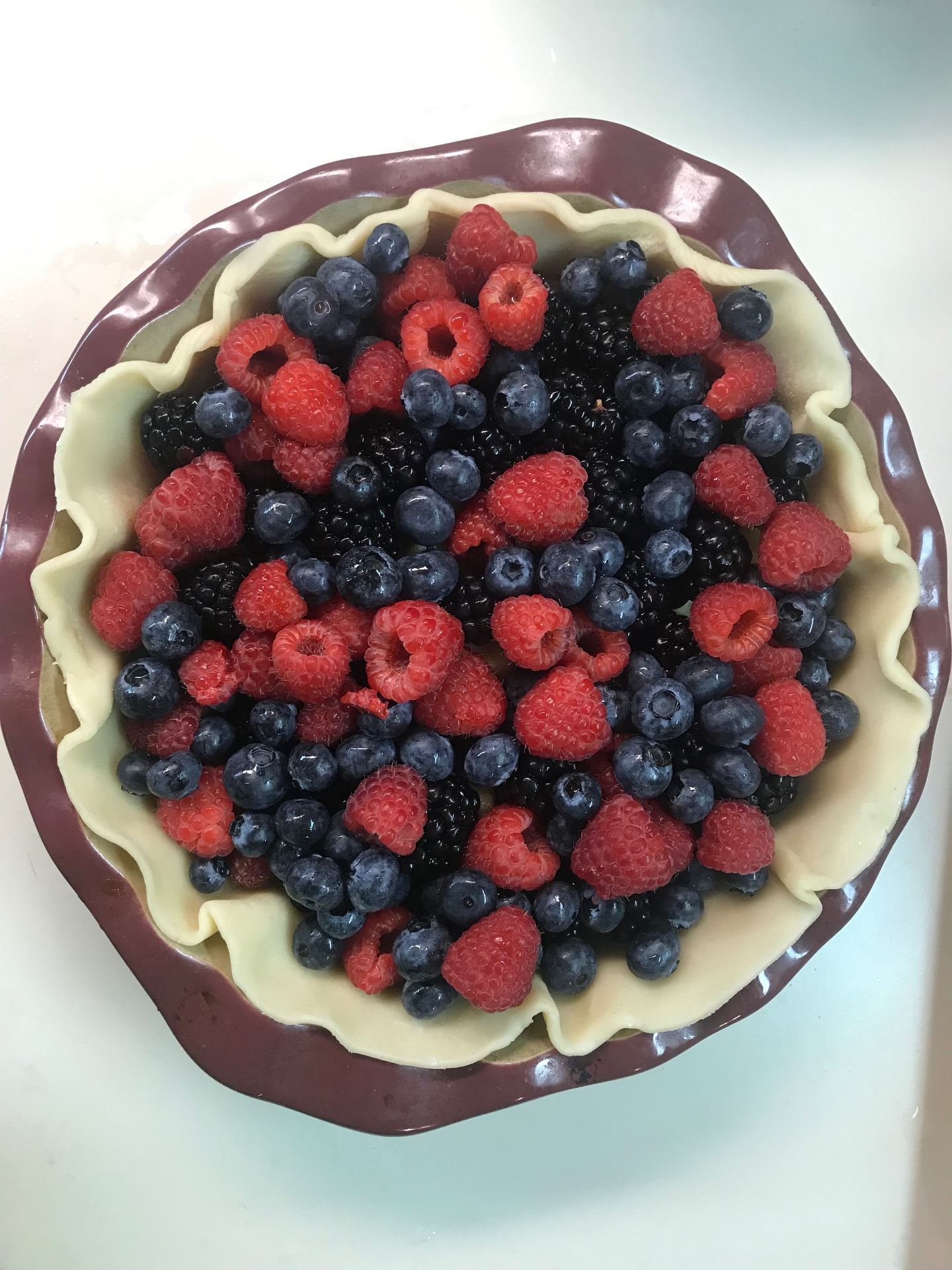Fresh berry pie with raspberries, blueberries, and blackberries